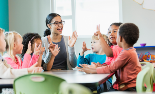 Students learning with teacher in a classroom