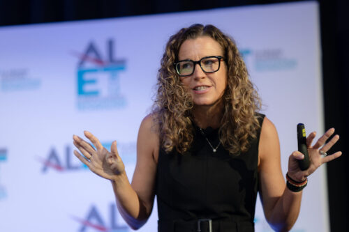 Andrea Gribble speaking onstage at an event
